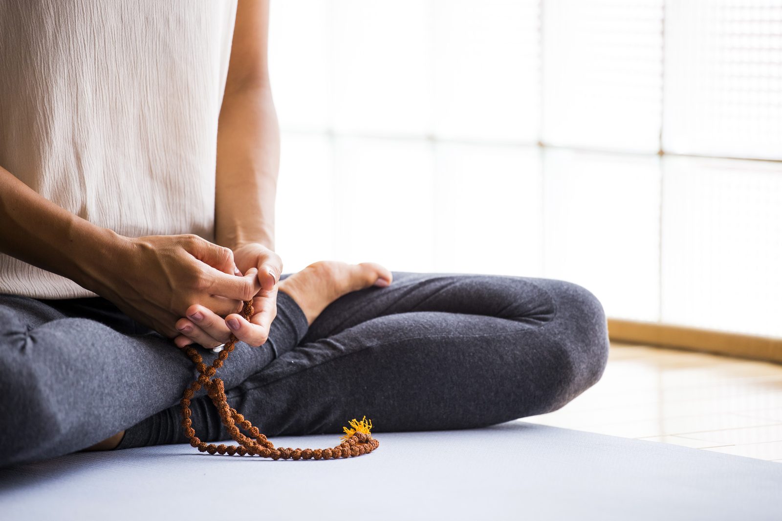Meditation beads and crystals arranged on a soft surface